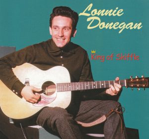 Lonnie Donegan (1931-2002), king of skiffle, inspired British youth, including Lennon, to play music. Here he is, playing the D chord of Rock Island Line! Click on the image to hear and see him play it. Lonnie Donegan, skiffle