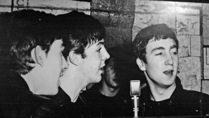 George, Paul and John. Looks like the Cavern circa 1961, with drummer Pete Best in the background. George Harrison, Paul McCartney, John Lennon, Cavern, Pete Best