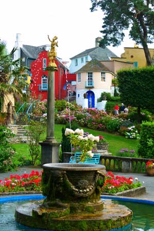 Portmeirion - fountain in the Piazza surrounded by colourful flowers
